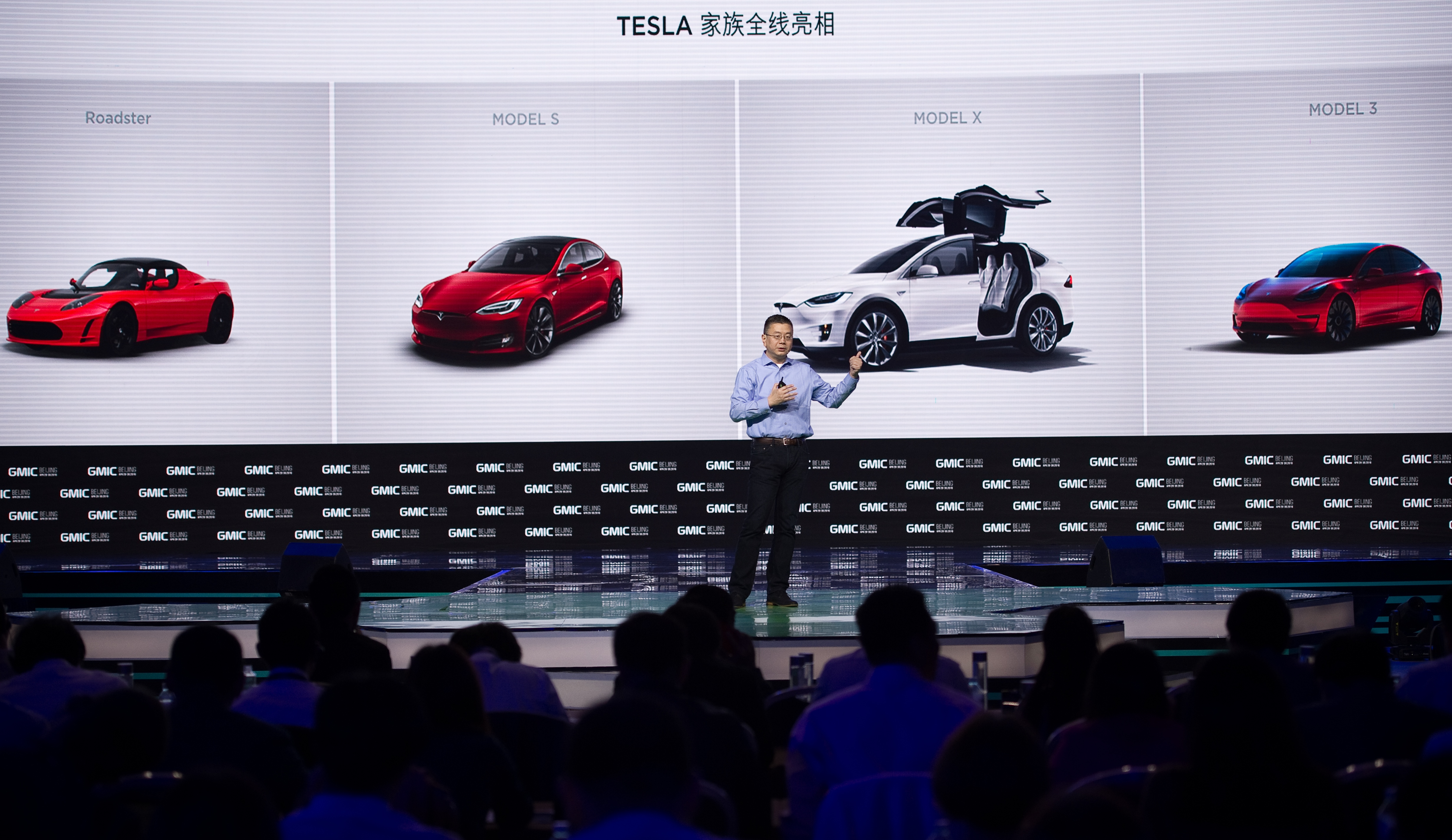Robin Ren Global VP and Head of APAC Tesla Motors makes a speech during the Global Mobile Internet Conference (GMIC) at the National Convention Centre in Beijing on April 28, 2016. GMIC is hosting mobile executives, entrepreneurs, developers, and investors from around the world. / AFP PHOTO / NICOLAS ASFOURI