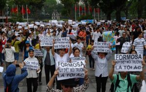 Vietnamese protesters demonstrate against Taiwanese conglomerate Formosa during a rally in downtown Hanoi on May 1, 2016. Around a thousand people poured into Vietnam's two major cities Hanoi and Ho Chi Minh City to protest against Taiwan's Formosa, which operates a steel plant which they claim is causing mass fish kills due to pollution in Vietnam's central coast. / AFP PHOTO / HOANG DINH NAM