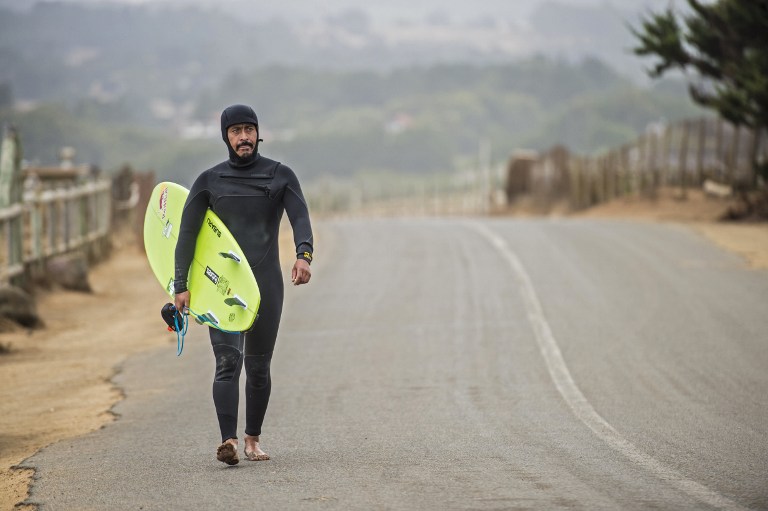 (FILES) This file photo taken on March 16, 2016 shows Chilean surfer Ramon Navarro heading for the beach of Punta Lobos, Pichilemu, around 200 km south of Santiago, on March 16, 2016. Navarro is one of the top big-wave surfers in the world, but this fisherman's son still has a special place in his heart for the spot where he learned his trade -- a stretch of Chilean coastline he is now fighting to save. / AFP PHOTO / Martin BERNETTI