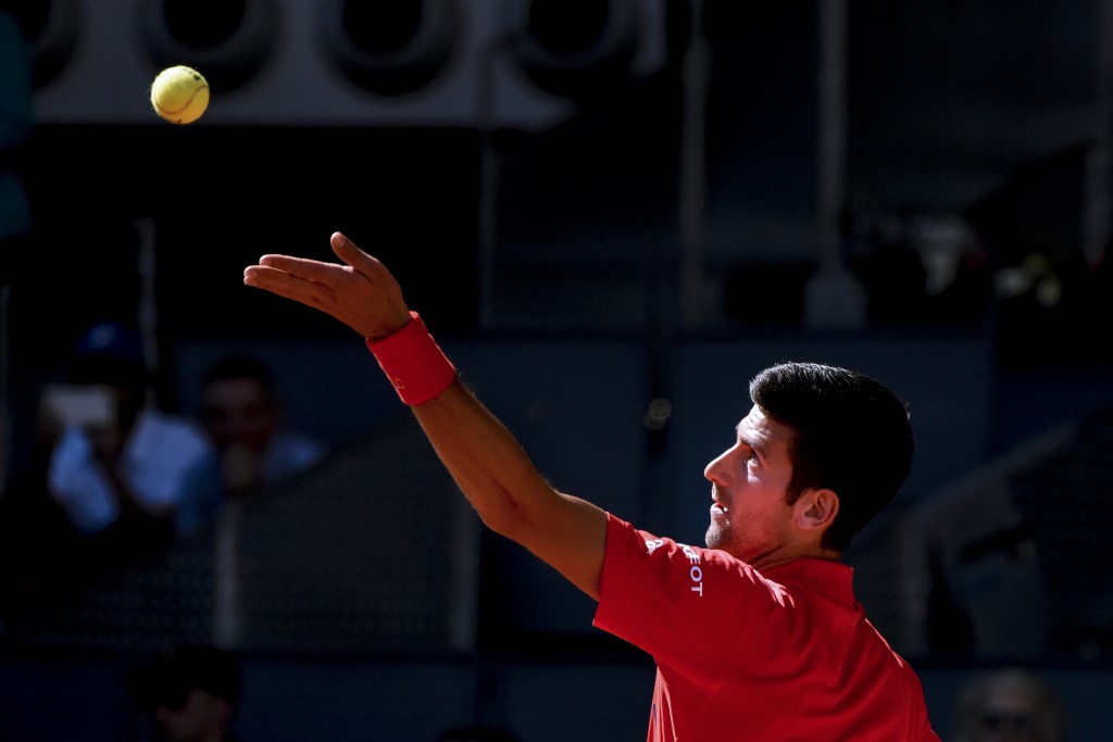 Serbian tennis player Novak Djokovic serves to Croatian tennis player Borna Coric during the Madrid Open tournament at the Caja Magica (Magic Box) sports complex in Madrid on May 4, 2016. / AFP PHOTO / PEDRO ARMESTRE