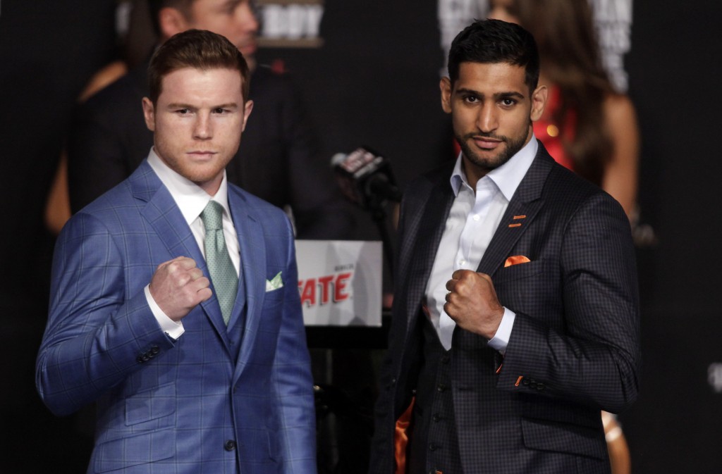Boxer Saul 'Canelo' Alvarez from Mexico (L) and England's Amir Khan (2R) pose during their final press conference at the MGM Grand in Las Vegas, Nevada on May 4, 2016 .  The boxers will fight for the WBC Middleweight title on May 7, 2016 at the T-Mobile Arena in Las Vegas.   / AFP PHOTO / John Gurzinski / The erroneous mention[s] appearing in the metadata of this photo by John Gurzinski has been modified in AFP systems in the following manner: [Middleweight] instead of [Welterweight]. Please immediately remove the erroneous mention[s] from all your online services and delete it (them) from your servers. If you have been authorized by AFP to distribute it (them) to third parties, please ensure that the same actions are carried out by them. Failure to promptly comply with these instructions will entail liability on your part for any continued or post notification usage. Therefore we thank you very much for all your attention and prompt action. We are sorry for the inconvenience this notification may cause and remain at your disposal for any further information you may require.
