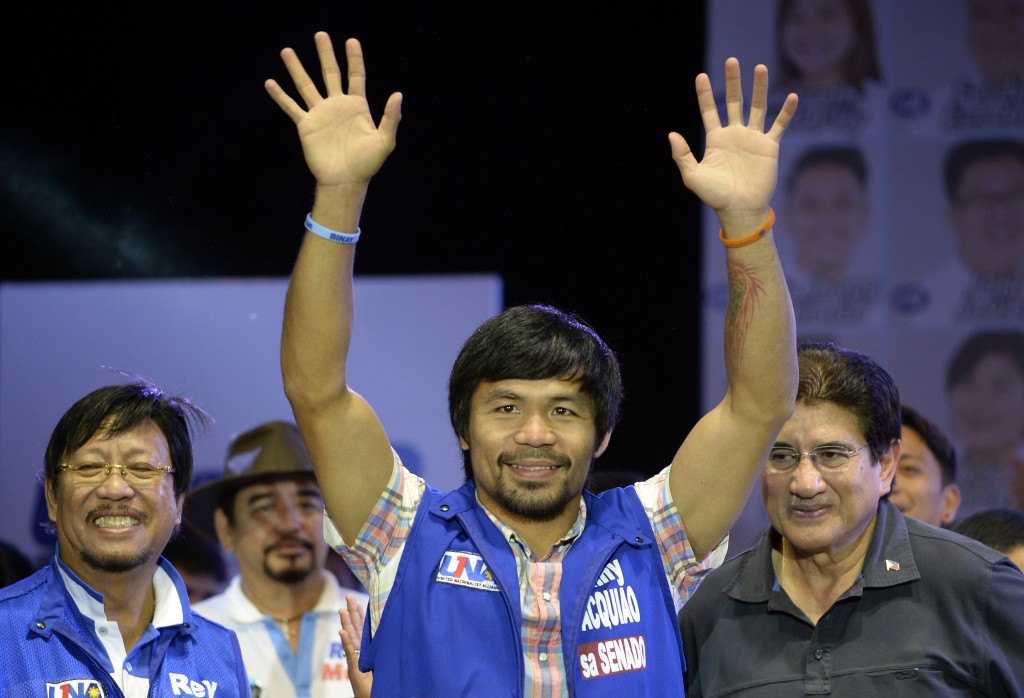Philippine boxing champion and senatorial candidate Manny Pacquiao speaks onstage during presidential candidate and Vice President Jejomar Binay's Miting De Avance in Manila on May 7, 2016. Philippine President Benigno Aquino warned May 7 the frontrunner in the race to replace him carried similar dangers to Hitler and would bring terror to the nation. / AFP PHOTO / NOEL CELIS
