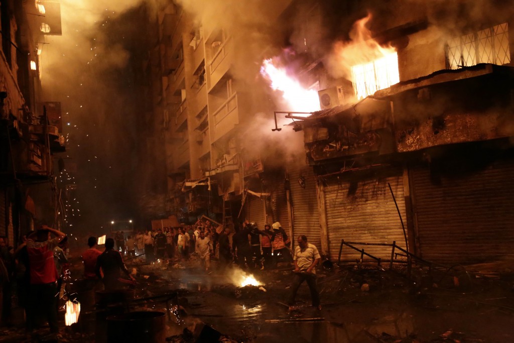Egyptian firefighters extinguish fire at the popular market area of al-Atabaa in downtown Cairo, on May 9, 2016. At least 50 people including firefighters suffered minor injuries when a fire spread quickly through a commercial area in downtown Cairo, Egyptian officials said. The fire erupted overnight in a small hotel in the Al-Mosky neighbourhood, not far from the Al-Azhar mosque, and moved rapidly to four nearby buildings, police told AFP. / AFP PHOTO / AHMED ABD EL-GAWAD