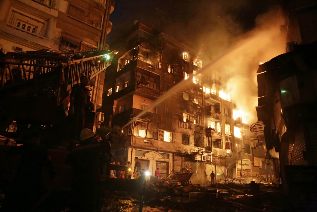 Egyptian firefighters extinguish fire at the popular market area of al-Atabaa in downtown Cairo, on May 9, 2016. At least 50 people including firefighters suffered minor injuries when a fire spread quickly through a commercial area in downtown Cairo, Egyptian officials said. The fire erupted overnight in a small hotel in the Al-Mosky neighbourhood, not far from the Al-Azhar mosque, and moved rapidly to four nearby buildings, police told AFP. / AFP PHOTO / AHMED ABD EL-GAWAD