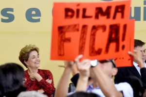 Brazilian President Dilma Rousseff and a placard that reads "Dilma Stays" are depicted during a ceremony to announce the creation new public universities, at Planalto Palace in Brasilia, on May 9, 2016. The impeachment of Brazilian President Dilma Rousseff was thrown into confusion when Waldir Maranhao, the interim speaker of the lower house of Congress annulled on May 9, 2016 an April vote by lawmakers to launch the process. He wrote in an order that a new vote should take place on whether to impeach Rousseff. / AFP PHOTO / EVARISTO SA