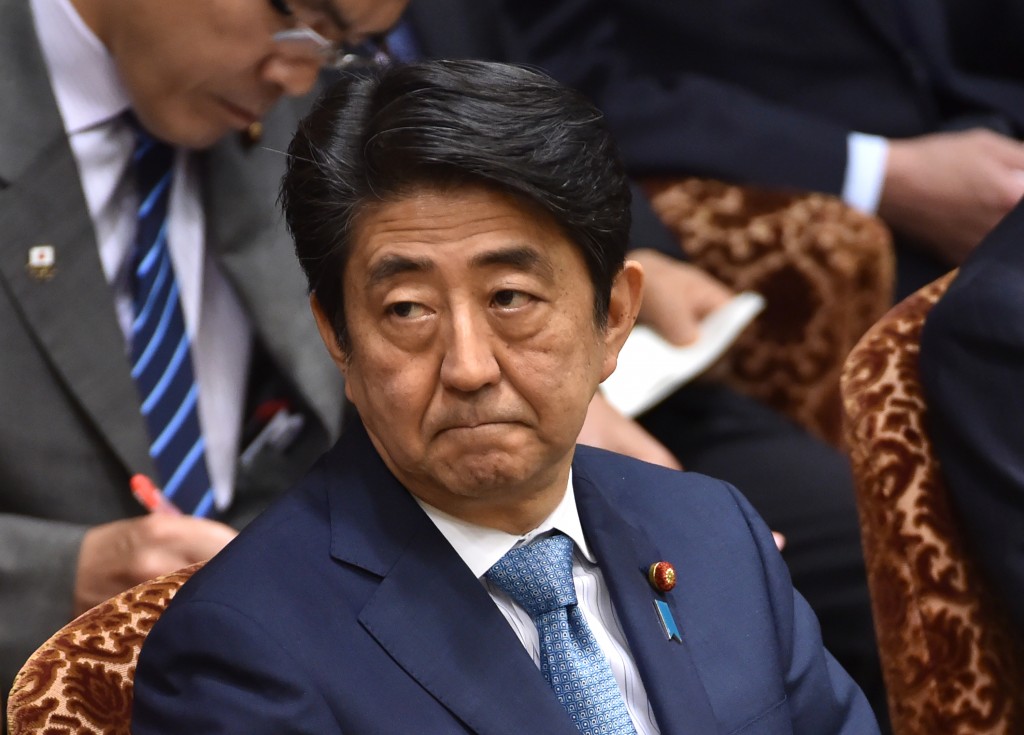 This picture taken on May 13, 2016 shows Japanese Prime Minister Shinzo Abe attending a budget committee session of the House of Councillors in Tokyo.  Abe has decided to postpone a sales tax hike a second time, judging that boosting the tariff could hurt the world's third-largest economy, a newspaper said May 14. / AFP PHOTO / KAZUHIRO NOGI