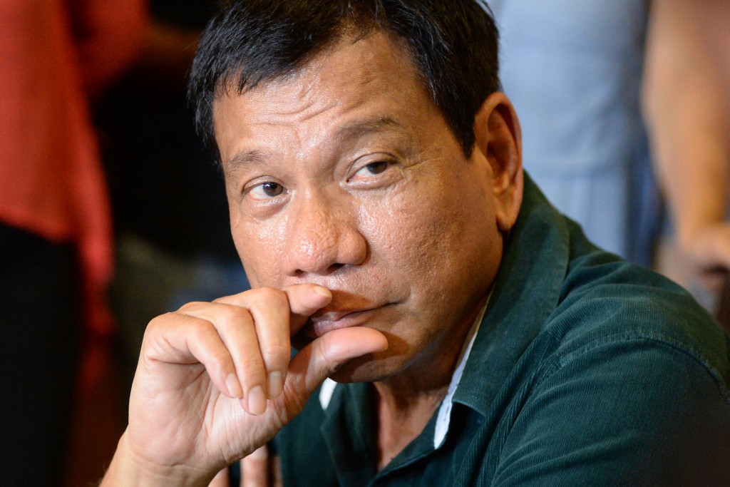 Philippine President-elect Rodrigo Duterte speaks during his first press conference since he claimed victory in the presidential election, at a restaurant in Davao City, on the southern island of Mindanao on May 15, 2016. Duterte vowed on May 15 to reintroduce capital punishment and give security forces "shoot-to-kill" orders in a devastating war on crime. / AFP PHOTO / TED ALJIBE