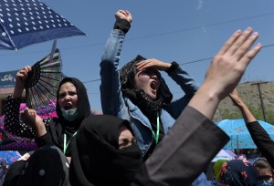 Afghan protesters chant anti-government slogans during a demonstration in Kabul on May 16, 2016, held to demand that The Turkmenistan-Uzbekistan-Tajikistan-Afghanistan-Pakistan (TUTAP) electricity project cross through the Salang Highway.  Afghanistan's capital was under lockdown on May 16, as thousands of minority Shiite Hazaras launched protests over a multi-million-dollar power transmission line, in what could snowball into a political crisis for the beleaguered government. Security forces blocked key intersections with stacked-up shipping containers in Kabul as the protesters sought to march on the presidential palace, demanding that the electricity line linking energy-rich central Asia pass through a central Hazara-dominated area.  / AFP PHOTO / SHAH MARAI