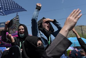 Afghan protesters chant anti-government slogans during a demonstration in Kabul on May 16, 2016, held to demand that The Turkmenistan-Uzbekistan-Tajikistan-Afghanistan-Pakistan (TUTAP) electricity project cross through the Salang Highway. Afghanistan's capital was under lockdown on May 16, as thousands of minority Shiite Hazaras launched protests over a multi-million-dollar power transmission line, in what could snowball into a political crisis for the beleaguered government. Security forces blocked key intersections with stacked-up shipping containers in Kabul as the protesters sought to march on the presidential palace, demanding that the electricity line linking energy-rich central Asia pass through a central Hazara-dominated area. / AFP PHOTO / SHAH MARAI