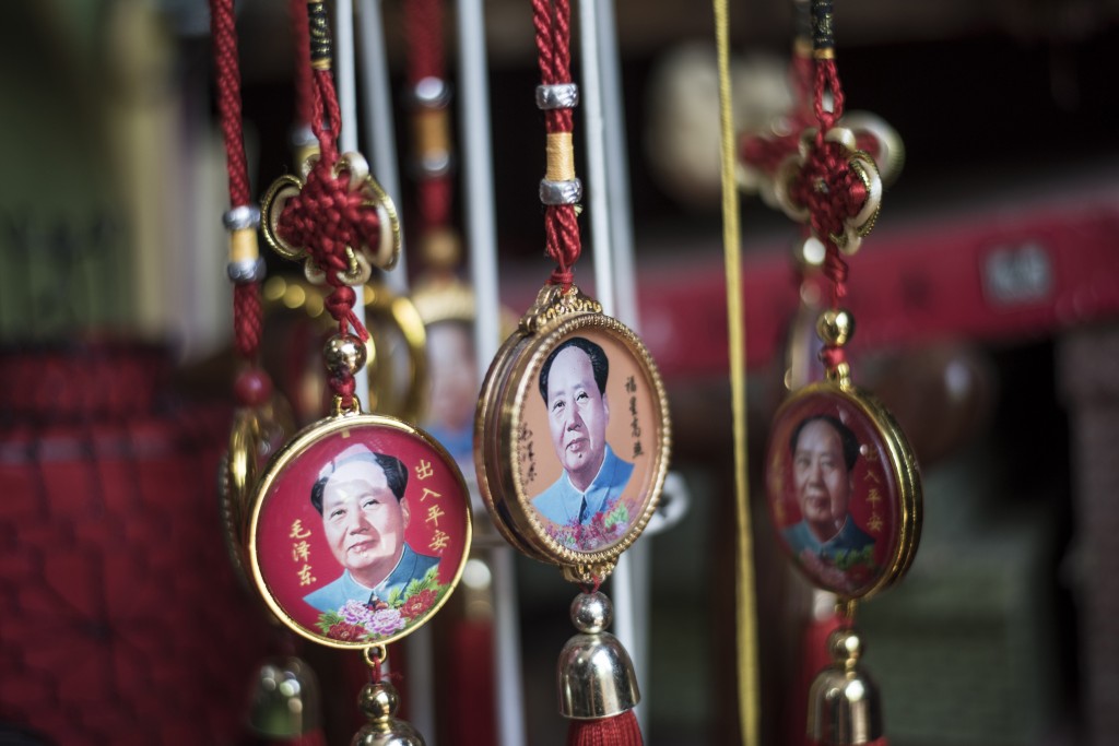 Pendants with portraits of late Chinese chairman Mao Zedong are seen for sale in a shop in Beijing on May 16, 2016. Official Chinese media stayed largely silent about Monday's 50th anniversary of the start of the bloody Cultural Revolution, with discussion of the tumultuous decade still controlled on the mainland. / AFP PHOTO / FRED DUFOUR