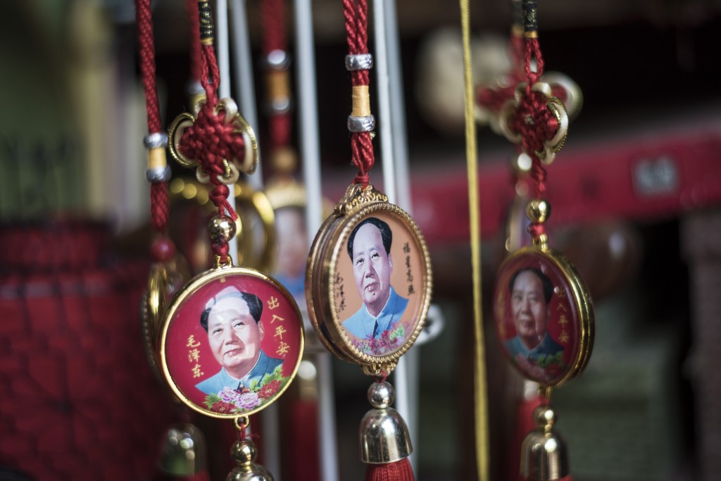Pendants with portraits of late Chinese chairman Mao Zedong are seen for sale in a shop in Beijing on May 16, 2016.  Official Chinese media stayed largely silent about Monday's 50th anniversary of the start of the bloody Cultural Revolution, with discussion of the tumultuous decade still controlled on the mainland. / AFP PHOTO / FRED DUFOUR