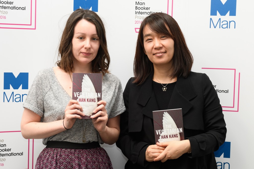 (FILES) This file photo taken on May 15, 2016 shows Korean author Han Kang (R) and translator Deborah Smith as they pose for a photograph with the book "The Vegetarian" at a photocall in London on May 15, 2016. The Vegetarian by Han Kang, translated by Smith, won the 2016 Man Booker International Prize at a ceremony in London on May 16, 2016. / AFP PHOTO / Leon NEAL
