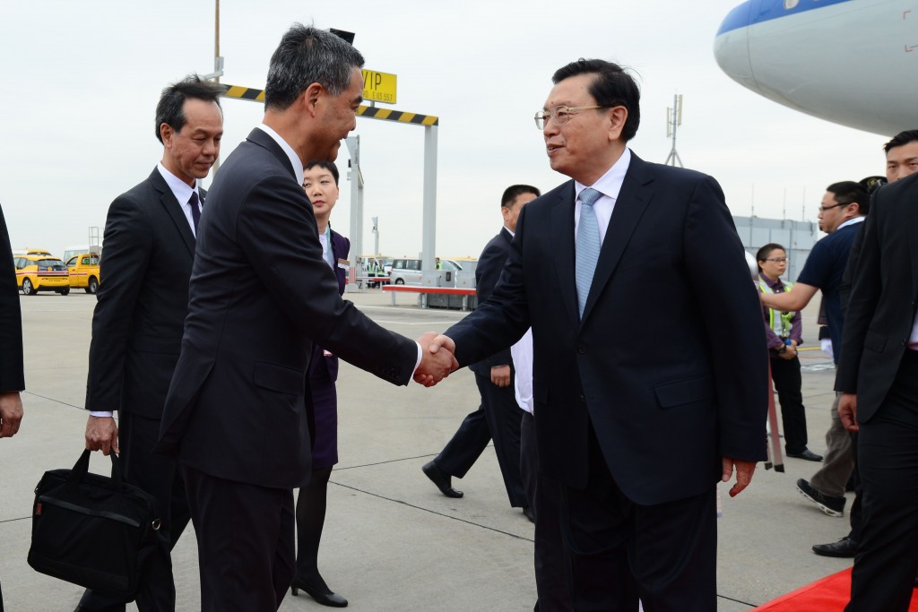This handout taken and received by Hong Kong's Information Services Department on May 17, 2016 shows Zhang Dejiang (R), who chairs China's communist-controlled legislature, shaking hands with Hong Kong's Chief Executive Leung Chun-ying (2nd L) upon his arrival at Hong Kong's international airport. The three-day trip by Zhang is the first by such a senior official in four years and comes as concerns grow in semi-autonomous Hong Kong that its long-cherished freedoms are under threat. / AFP PHOTO / INFORMATION SERVICES DEPARTMENT / STR / -----EDITORS NOTE --- RESTRICTED TO EDITORIAL USE - MANDATORY CREDIT "AFP PHOTO / INFORMATION SERVICES DEPARTMENT" - NO MARKETING - NO ADVERTISING CAMPAIGNS - DISTRIBUTED AS A SERVICE TO CLIENTS