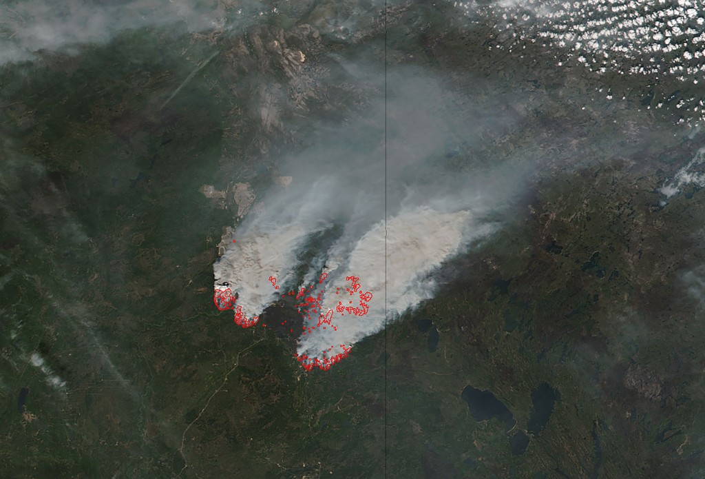 In this NASA satellite image obtained May 17, 2016, smoke from wildfires burning near Fort Mcmurray, Canada can be seen. Mandatory evacuation orders were issued for some 20 oil sands camps and facilities in Canada's Alberta province due to smoke and flames from the Fort McMurray wildfire, regional emergency officials said May 17, 2016. The evacuation orders, which affect some 8,000 people, were issued late Monday (0200 GMT Tuesday) for a region between Fort McMurray and a few kilometers south of the town of Fort MacKay, officials said. / AFP PHOTO / NASA / HO / RESTRICTED TO EDITORIAL USE - MANDATORY CREDIT "AFP PHOTO / NASA" - NO MARKETING - NO ADVERTISING CAMPAIGNS - DISTRIBUTED AS A SERVICE TO CLIENTS