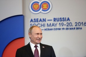 Russian President Vladimir Putin smiles during the welcoming ceremony for heads of the delegations at the Russia-ASEAN summit in Sochi on May 20, 2016. / AFP PHOTO / Host Photo Agency / -