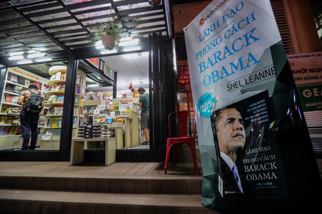 A poster featuring the book "Leadership, the Barack Obama way" by Shel Leanne translated into Vietnamese is placed at the entrance gate of a book store in Ho Chi Minh City on May 21, 2016. Obama is expected to arrive for a three-day state visit to Vietnam on May 23. Obama will be the third US president in office to visit its former foe since the end of the Vietnam War in April 1975. / AFP PHOTO / LE QUANG NHAT