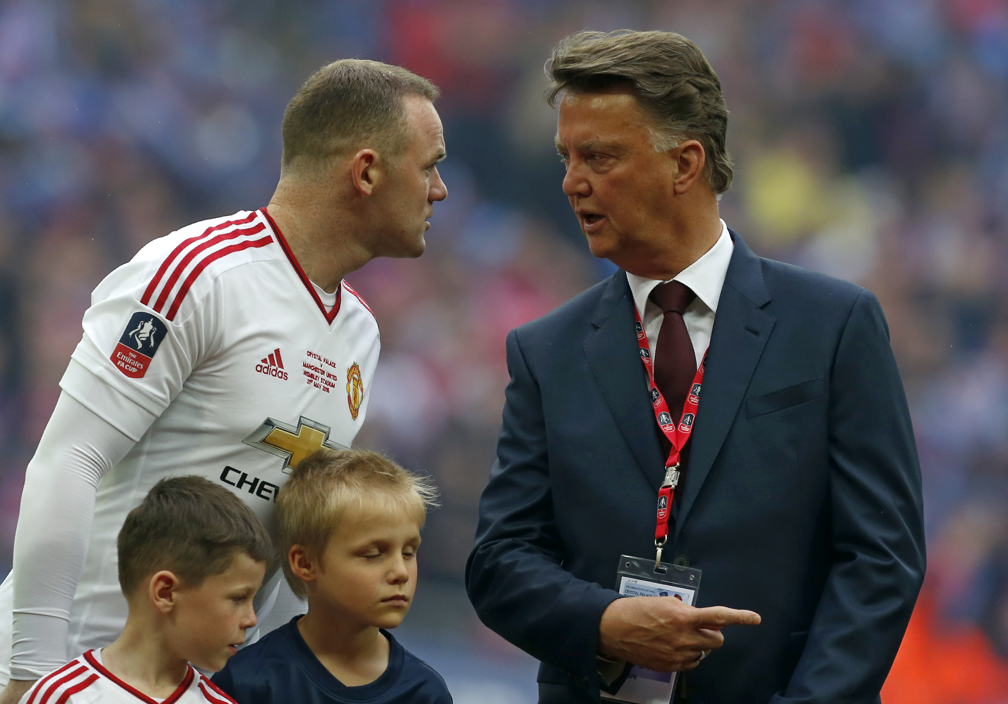 Manchester United's Dutch manager Louis van Gaal (R) speaks with Manchester United's English striker Wayne Rooney before the start of the FA Cup trophy following the English FA Cup final football match between Crystal Palace and Manchester United at Wembley stadium in London on May 21, 2016. / AFP PHOTO / Ian Kington / NOT FOR MARKETING OR ADVERTISING USE / RESTRICTED TO EDITORIAL USE