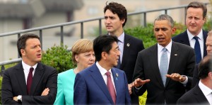 Japanese Prime Minister Shinzo Abe (C) listens to US President Barack Obama (2nd R) while walking to their family photo event with other leaders during the first day of the Group of Seven (G7) summit meetings in in Ise city on May 26, 2016.  World leaders kick off two days of G7 talks in Japan on May 26 with the creaky global economy, terrorism, refugees, China's controversial maritime claims, and a possible Brexit headlining their packed agenda. World leaders kicked off two days of G7 talks in Japan on May 26 with the creaky global economy, terrorism, refugees, China's controversial maritime claims, and a possible Brexit headlining their packed agenda. / AFP PHOTO / POOL / JAPAN POOL / Japan OUT