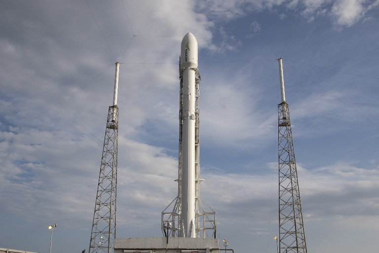 In this photo released by Space X's, the Thaicom 8 rocket waits to lift off from space launch complex 40 at Cape Canaveral, Florida on May 24, 2016. SpaceX launched an Asian communications satellite into a distant orbit on May 27, 2016 and for the fourth time managed to recover the rocket that did the work.Under blue skies dotted with clouds, the shiny white Falcon 9 rocket blasted off from Cape Canaveral, Florida at 5:40 pm (2140 GMT) carrying the Thaicom 8 satellite. / AFP PHOTO / SPACEX / david hash / RESTRICTED TO EDITORIAL USE - MANDATORY CREDIT "AFP PHOTO / DAVID HASH/ SPACE X" - NO MARKETING - NO ADVERTISING CAMPAIGNS - DISTRIBUTED AS A SERVICE TO CLIENTS