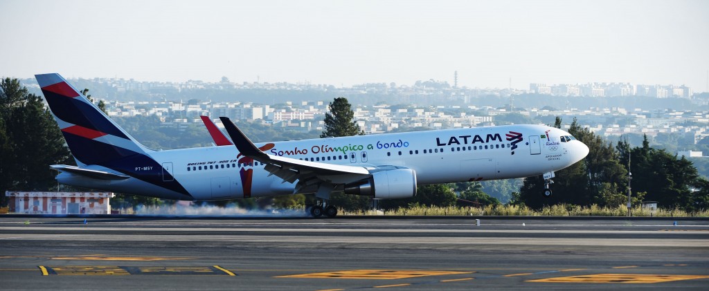 (FILES) This file photo taken on May 3, 2016 shows a LATAM Boeing 767-300ER aircraft transporting the Olympic flame as it arrives in Brasilia from Geneva. Latin America's biggest airline LATAM said on May 30, 2016, it will suspend its flights to crisis-hit Venezuela for an indefinite period, following a similar move by German carrier Lufthansa. / AFP PHOTO / EVARISTO SA