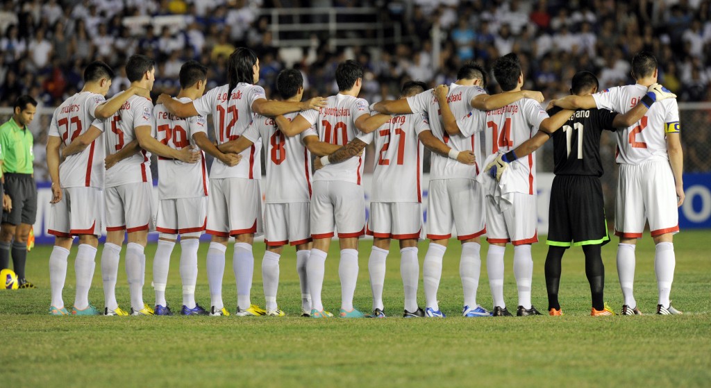 The Philippine Azkals  observe a minute of silence during the AFF Suzuki Cup 2012 first leg of the semi-finals at the Rizal Memorial Stadium, Manila on December 8, 2012. A minute of silence for Typhoon Bopha victims was observed when the disaster-struck Philippines hosted Singapore in the first leg of their Asian Football Federation Suzuki Cup semi-final. The pre-match silence will be in honour of the 540 people killed and nearly 400 others left missing after the cyclone struck the country's south, said Coco Torre, spokesman for the hosts.  AFP PHOTO / Jay DIRECTO / AFP PHOTO / JAY DIRECTO