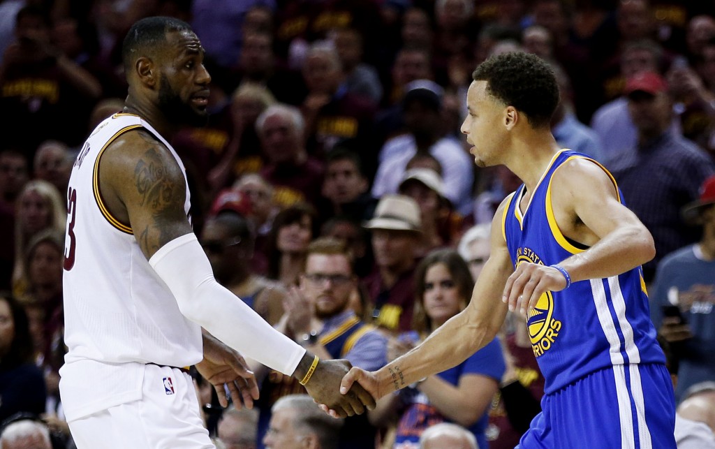 CLEVELAND, OH - JUNE 16: LeBron James #23 of the Cleveland Cavaliers shakes hands with Stephen Curry #30 of the Golden State Warriors after the Warriors defeated the Cavs 105 to 97 to win Game Six of the 2015 NBA Finals at Quicken Loans Arena on June 16, 2015 in Cleveland, Ohio. NOTE TO USER: User expressly acknowledges and agrees that, by downloading and or using this photograph, user is consenting to the terms and conditions of Getty Images License Agreement.   Ezra Shaw/Getty Images/AFP
