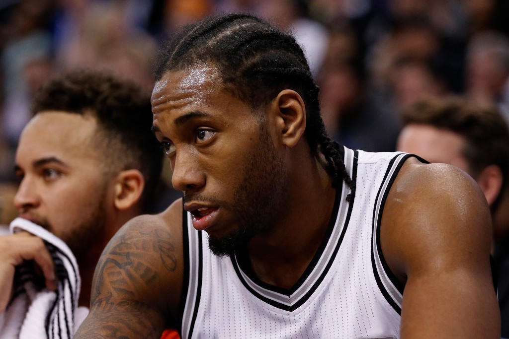 PHOENIX, AZ - JANUARY 21: Kawhi Leonard #2 of the San Antonio Spurs watches from the bench during the second half of the NBA game against the Phoenix Suns at Talking Stick Resort Arena on January 21, 2016 in Phoenix, Arizona. The Spurs defeated the Suns 117-89. NOTE TO USER: User expressly acknowledges and agrees that, by downloading and or using this photograph, User is consenting to the terms and conditions of the Getty Images License Agreement.   Christian Petersen/Getty Images/AFP
