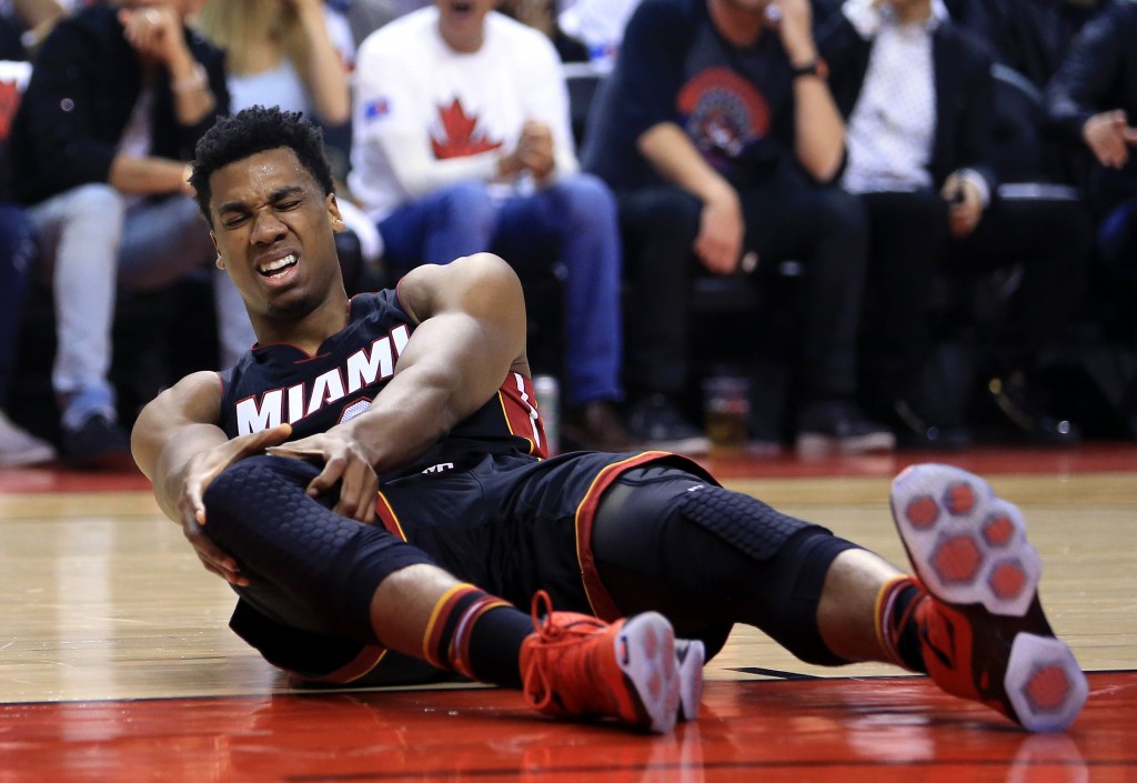 TORONTO, ON - MAY 03: Hassan Whiteside #21 of the Miami Heat injures his knee in the first half of Game One of the Eastern Conference Semifinals against the Toronto Raptors during the 2016 NBA Playoffs at the Air Canada Centre on May 3, 2016 in Toronto, Ontario, Canada. NOTE TO USER: User expressly acknowledges and agrees that, by downloading and or using this photograph, User is consenting to the terms and conditions of the Getty Images License Agreement. Vaughn Ridley/Getty Images/AFP