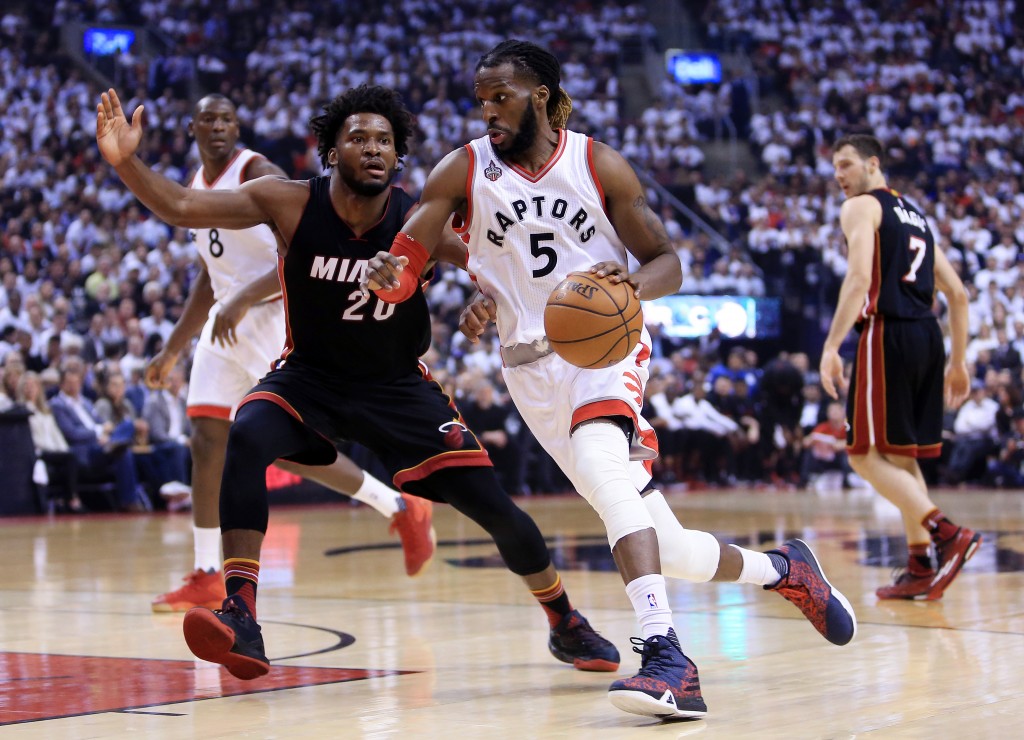 TORONTO, ON - MAY 05: DeMarre Carroll #5 of the Toronto Raptors dribbles the ball as Justice Winslow #20 of the Miami Heat defends in the first half of Game Two of the Eastern Conference Semifinals during the 2016 NBA Playoffs at the Air Canada Centre on May 5, 2016 in Toronto, Ontario, Canada. NOTE TO USER: User expressly acknowledges and agrees that, by downloading and or using this photograph, User is consenting to the terms and conditions of the Getty Images License Agreement.   Vaughn Ridley/Getty Images/AFP