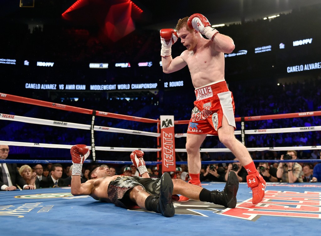 LAS VEGAS, NEVADA - MAY 07: Canelo Alvarez (R) stands over Amir Khan after delivering a knockout punch during the sixth round of their WBC middleweight title fight at T-Mobile Arena on May 7, 2016 in Las Vegas, Nevada.   David Becker/Getty Images/AFP