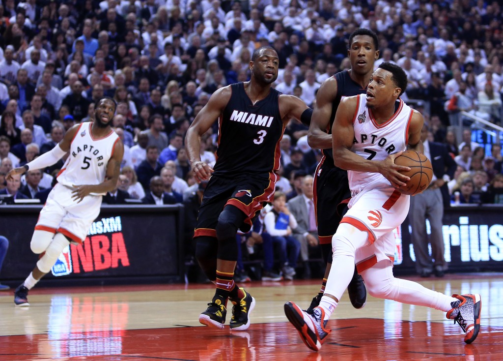 TORONTO, ON - MAY 11: Kyle Lowry #7 of the Toronto Raptors drives to the basket as Dwyane Wade #3 and Josh Richardson #0 of the Miami Heat defend in the first half of Game Five of the Eastern Conference Semifinals during the 2016 NBA Playoffs at the Air Canada Centre on May 11, 2016 in Toronto, Ontario, Canada. NOTE TO USER: User expressly acknowledges and agrees that, by downloading and or using this photograph, User is consenting to the terms and conditions of the Getty Images License Agreement.   Vaughn Ridley/Getty Images/AFP