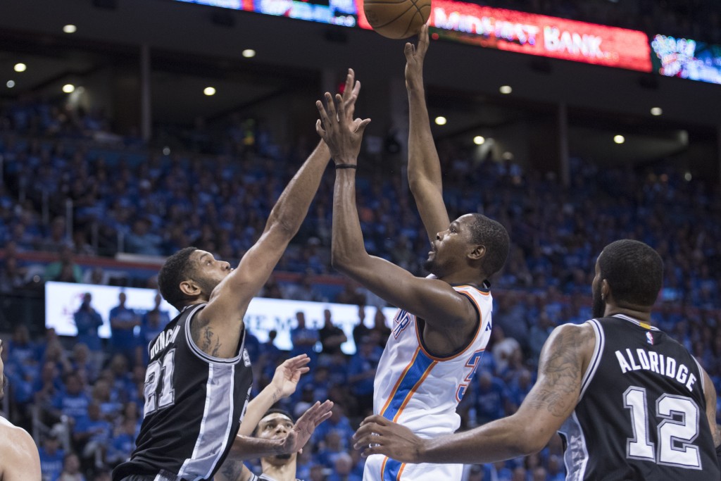 OKLAHOMA CITY, OK - MAY 12: Kevin Durant #35 of the Oklahoma City Thunder shoots over Tim Duncan #21 of the San Antonio Spurs during the first half of Game Six of the Western Conference Semifinals during the 2016 NBA Playoffs at the Chesapeake Energy Arena on May 12, 2016 in Oklahoma City, Oklahoma. NOTE TO USER: User expressly acknowledges and agrees that, by downloading and or using this photograph, User is consenting to the terms and conditions of the Getty Images License Agreement.   J Pat Carter/Getty Images/AFP