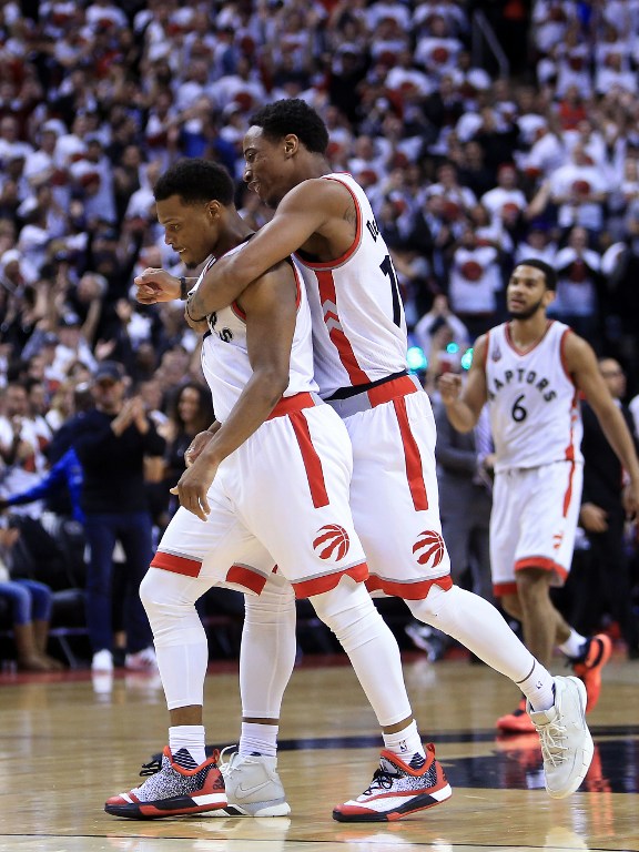 TORONTO, ON - MAY 15: DeMar DeRozan #10 and Kyle Lowry #7 of the Toronto Raptors celebrate late in the second half of Game Seven of the Eastern Conference Quarterfinals against the Miami Heat during the 2016 NBA Playoffs at the Air Canada Centre on May 15, 2016 in Toronto, Ontario, Canada. NOTE TO USER: User expressly acknowledges and agrees that, by downloading and or using this photograph, User is consenting to the terms and conditions of the Getty Images License Agreement.   Vaughn Ridley/Getty Images/AFP