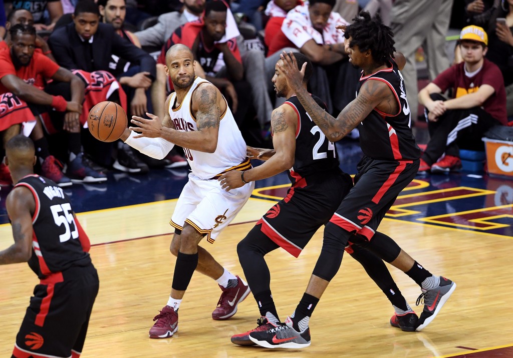 CLEVELAND, OH - MAY 17: Dahntay Jones #30 of the Cleveland Cavaliers looks to pass in the fourth quarter against Norman Powell #24 and Lucas Nogueira #92 of the Toronto Raptors in game one of the Eastern Conference Finals during the 2016 NBA Playoffs at Quicken Loans Arena on May 17, 2016 in Cleveland, Ohio. NOTE TO USER: User expressly acknowledges and agrees that, by downloading and or using this photograph, User is consenting to the terms and conditions of the Getty Images License Agreement.   Jason Miller/Getty Images/AFP