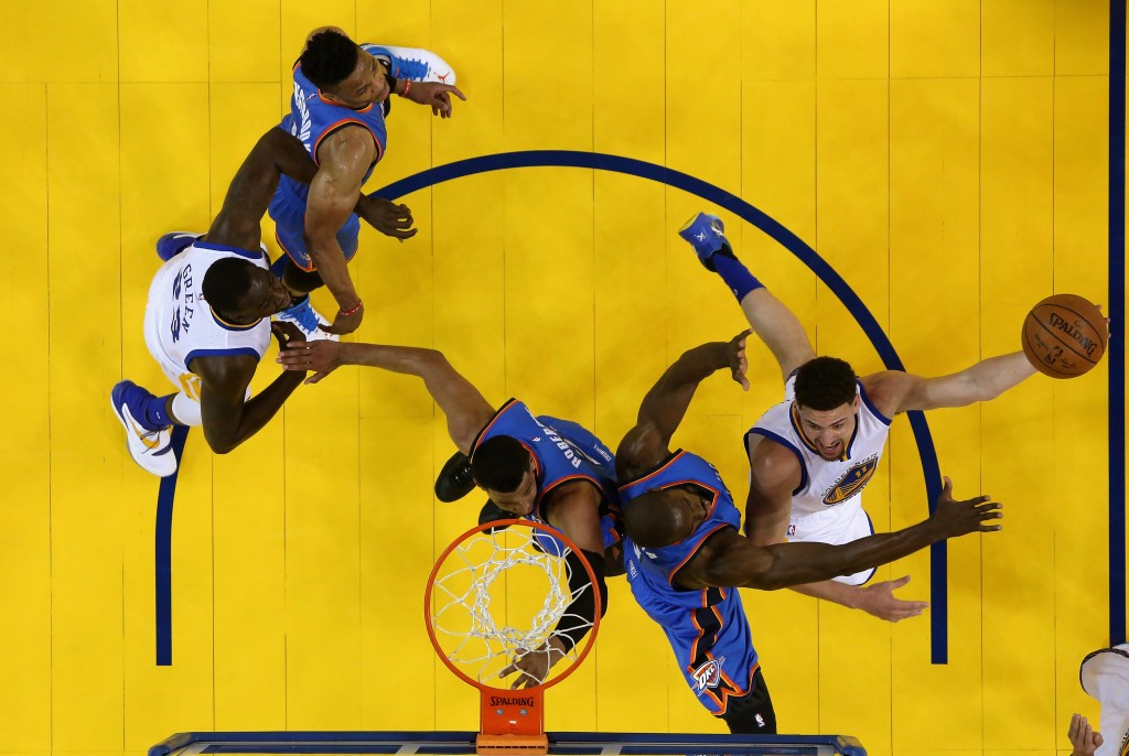 OAKLAND, CA - MAY 26: Klay Thompson #11 of the Golden State Warriors goes up for a shot against Serge Ibaka #9 and Andre Roberson #21 of the Oklahoma City Thunder during Game Five of the Western Conference Finals during the 2016 NBA Playoffs at ORACLE Arena on May 26, 2016 in Oakland, California. Ezra Shaw/Getty Images/AFP