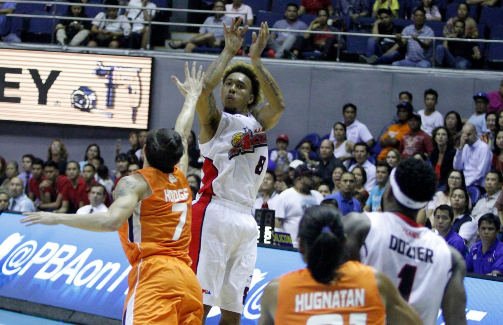 Alaska Aces forward Calvin Abueva shoots over Meralco forward Cliff Hodge during Game 5 of their PBA Commissioner's Cup semi-final on Wednesday. (Photo courtesy: PBA Media Bureau)