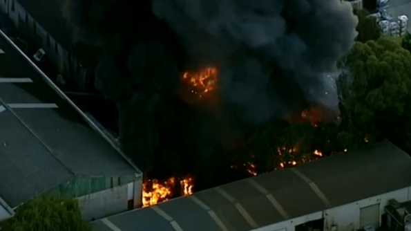 Over 100 firefighters needed to tackle a fire at a Sydney car dismantling yard that sent plumes of smoke over the city.(photo grabbed from Reuters video) 