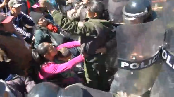 Bolivians in wheelchairs and their supporters hang themselves from La Paz overpass and clash with police in their bid for an increase in benefits.(photo grabbed from Reuters video) 
