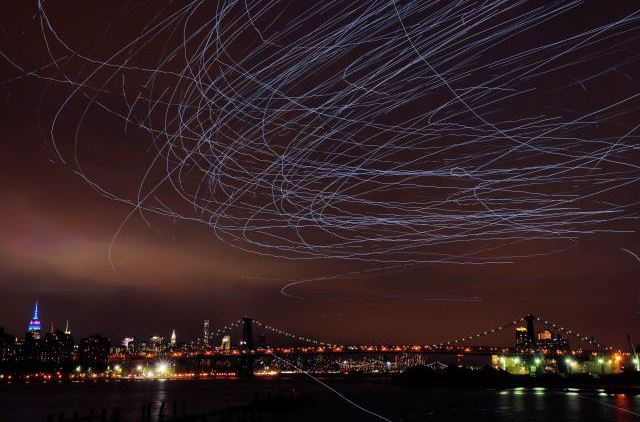 LED lights attached to pigeons leave light trails in the sky while they fly as part of the 'Fly By Night' art installation by Duke Riley above the Brooklyn borough of New York, U.S.,May 5, 2016. Reuters/Lucas Jackson
