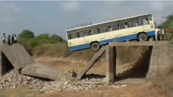 More than two dozen bus passengers have a miraculous escape after a bridge collapses in India, leaving the vehicle dangling precariously(photo grabbed from Reuters video)