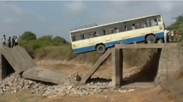 More than two dozen bus passengers have a miraculous escape after a bridge collapses in India, leaving the vehicle dangling precariously(photo grabbed from Reuters video) 