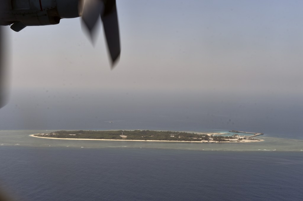 This aerial image taken from a C-130 transport plane shows a general view of Taiping island during a visit by journalists to the island, in the Spratlys chain in the South China Sea on March 23, 2016. Taiwan on March 23 gave its first ever international press tour of a disputed island in the South China Sea to boost its claim, less than two months after a visit by its leader sparked protests from rival claimants. / AFP PHOTO / SAM YEH