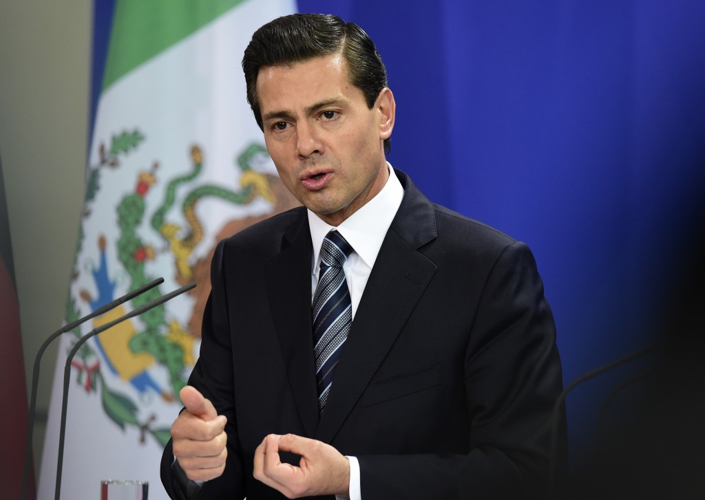 Mexican President Enrique Pena Nieto addresses a news conference following talks with the German Chancellor at the Chancellery in Berlin on April 12, 2016. / AFP PHOTO / TOBIAS SCHWARZ