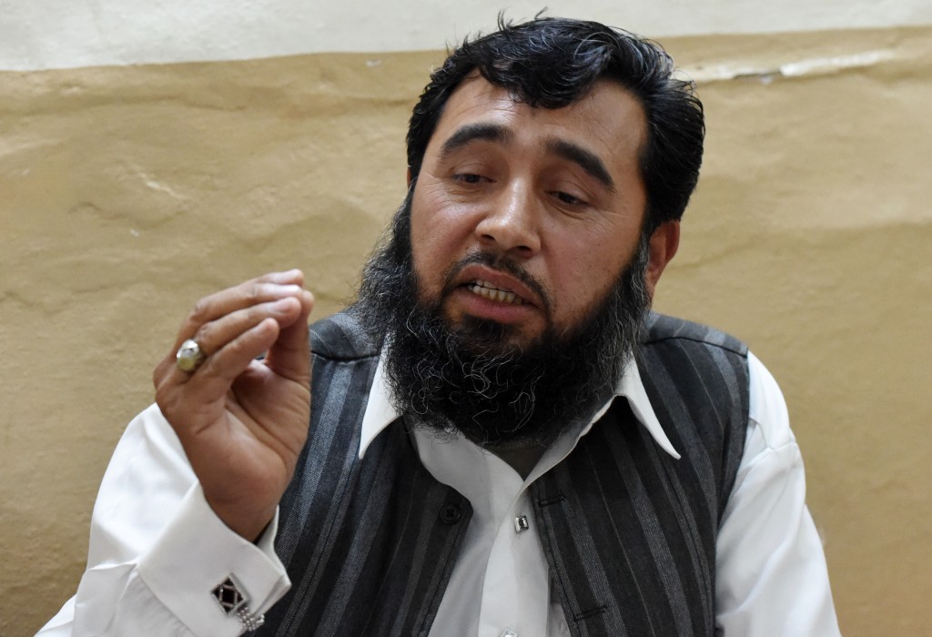 In this photograph taken on March 23, 2016, Pakistani father Sardar Haji Jan Mohammad Khilji gestures as he speaks with AFP during an interview at his residence in Quetta. A Pakistani father of 35 is now searching for a fourth wife as he romps towards his goal of 100 children, a dubious ambition in the conservative Muslim country where polygamy is rare but still practiced. / AFP PHOTO / BANARAS KHAN / TO GO WITH AFP STORY:  Pakistan-Social-Lifestyle, FEATURE by Maaz Khan