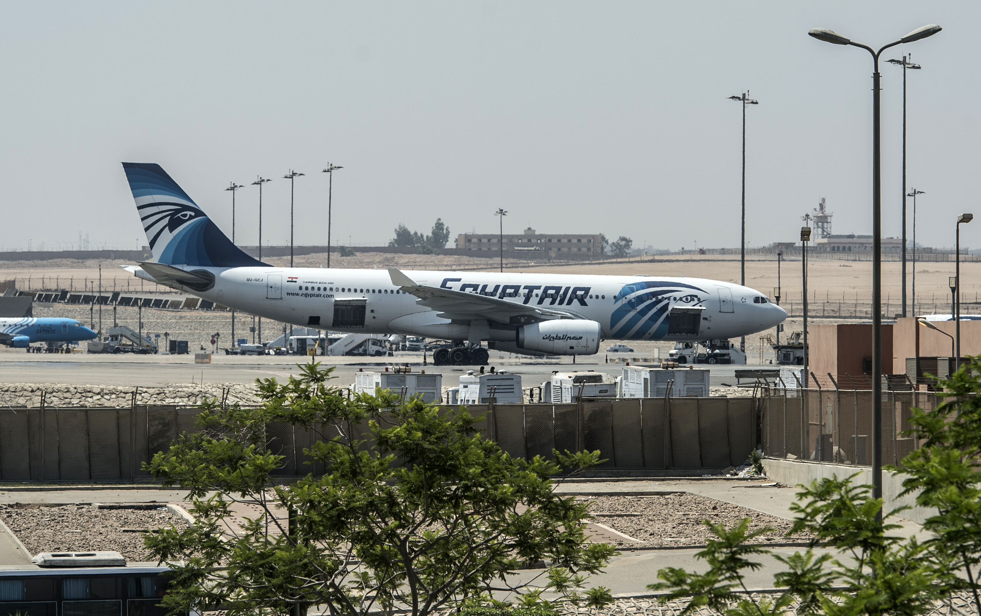An EgyptAir plane is seen on the tarmac at Cairo international airport on May 19, 2016 after an EgyptAir flight from Paris to Cairo crashed into the Mediterranean on with 66 people on board, prompting an investigation into whether it was mechanical failure or a bomb. Egypt's aviation minister said he could not rule out that an attack or a technical failure brought down the plane.  / AFP PHOTO / KHALED DESOUKI