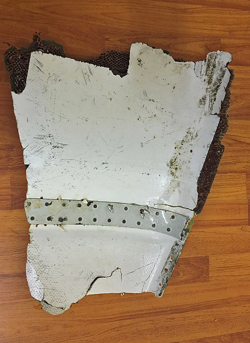 This hand out picture released on May 27, 2016 by the Mauritius National Coastguard shows an aircraft debris, suspected to be part of the missing MH370 Malaysian airlines plane, found at the Gris Gris public beach near Souillac, in the southern part of Mauritius Island on May 24.  The fate of the passenger jet, which is presumed to have crashed at sea after disappearing en route from Kuala Lumpur to Beijing with 239 passengers and crew on board in March 2014, remains a mystery. Five other fragments have previously been found and identified as definitely or probably from the Boeing 777. All of them were discovered thousands of kilometres (miles) from the current search zone far off Western Australia's coast.  / AFP PHOTO / Mauritius National Coastguard / - / RESTRICTED TO EDITORIAL USE - MANDATORY CREDIT "AFP PHOTO / Mauritius National Coastguard" - NO MARKETING NO ADVERTISING CAMPAIGNS - DISTRIBUTED AS A SERVICE TO CLIENTS