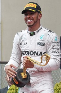 Mercedes AMG Petronas F1 Team's British driver Lewis Hamilton celebrates on the podium with his trophy the Monaco street circuit, on May 29, 2016 in Monaco, after the Monaco Formula 1 Grand Prix. / AFP PHOTO / PASCAL GUYOT