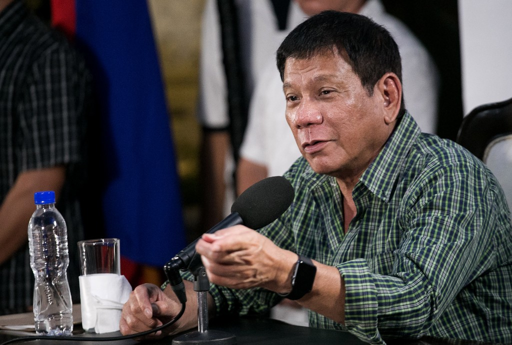 Philippines' president-elect Rodrigo Duterte speaks during a press conference in Davao on May 31, 2016. Philippine president-elect Rodrigo Duterte's war on crime appears to have begun ahead of him taking office, rights activists said May 31 as they voiced concern over a spate of police and vigilante killings. / AFP PHOTO / MANMAN DEJETO