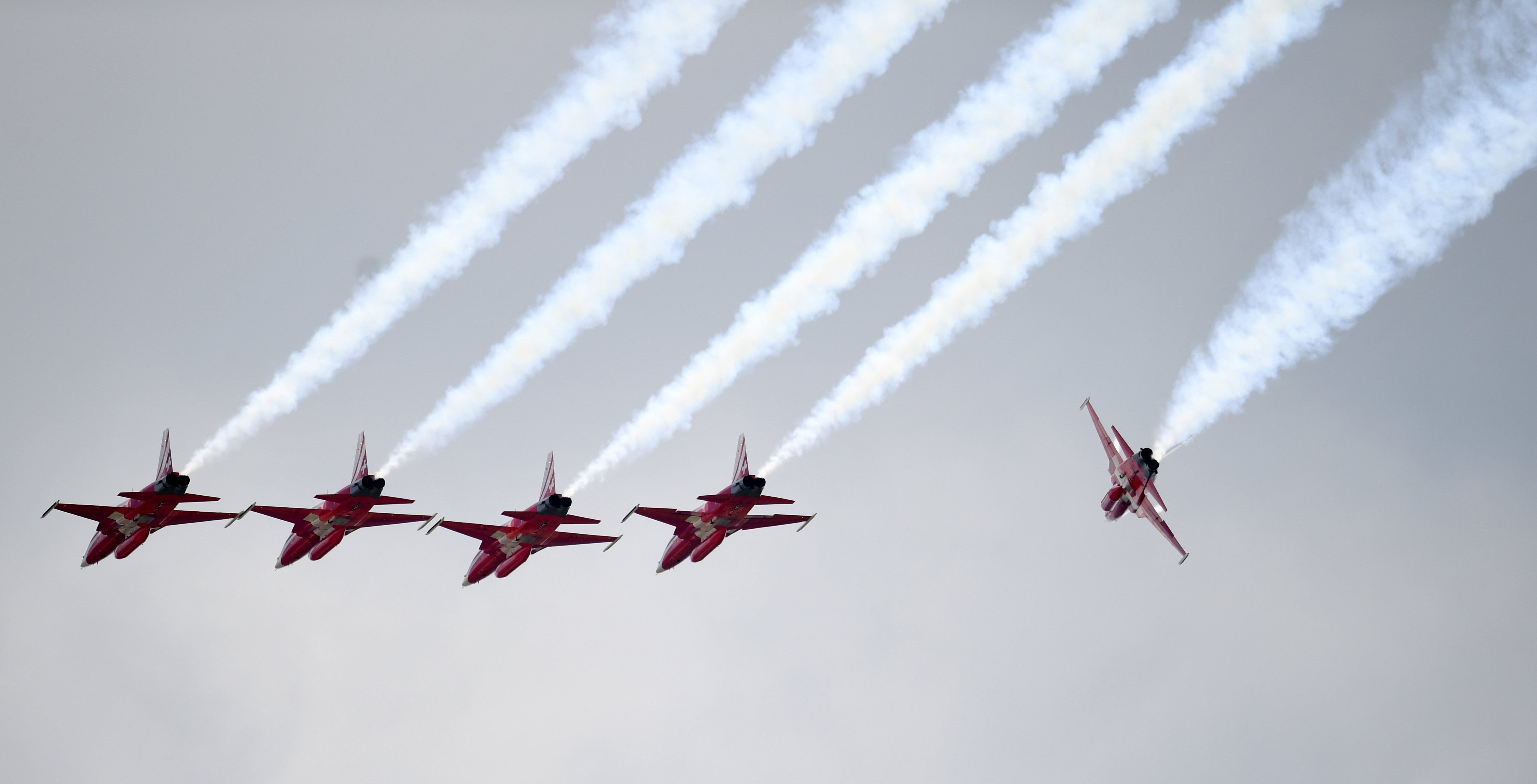 The Swiss Air Force 'Patrouille Suisse'planes perform at the International Aerospace Exhibition (ILA) in Schoenefeld near Berlin, on June 2, 2016. The Aerospace Exhibition at Schoenefeld Airport near Berlin takes place from June 1 till 4. / AFP PHOTO / Ralf Hirschberger / Germany OUT
