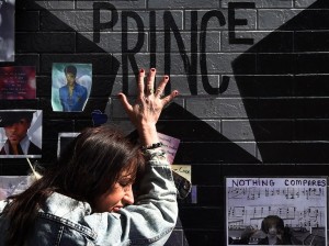 (FILES) This file photo taken on April 23, 2016 shows Prince fan Ann Sawatzky touching the star of music legend Prince who died suddenly at the age of 57, at the First Avenue club where he started his music career in Minneapolis, Minnesota, on April 23, 2016. Prince died from an overdose of painkillers, a report said on June 2, 2016, quoting the ongoing investigation. The Star Tribune newspaper in Prince's hometown Minneapolis quoted an anonymous source as saying that the singer had overdosed on opioid pain medication. Officials declined comment. / AFP PHOTO / Mark Ralston